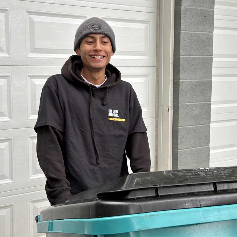 GM Junk removal professional removing an old trashcan during single item junk pickup services